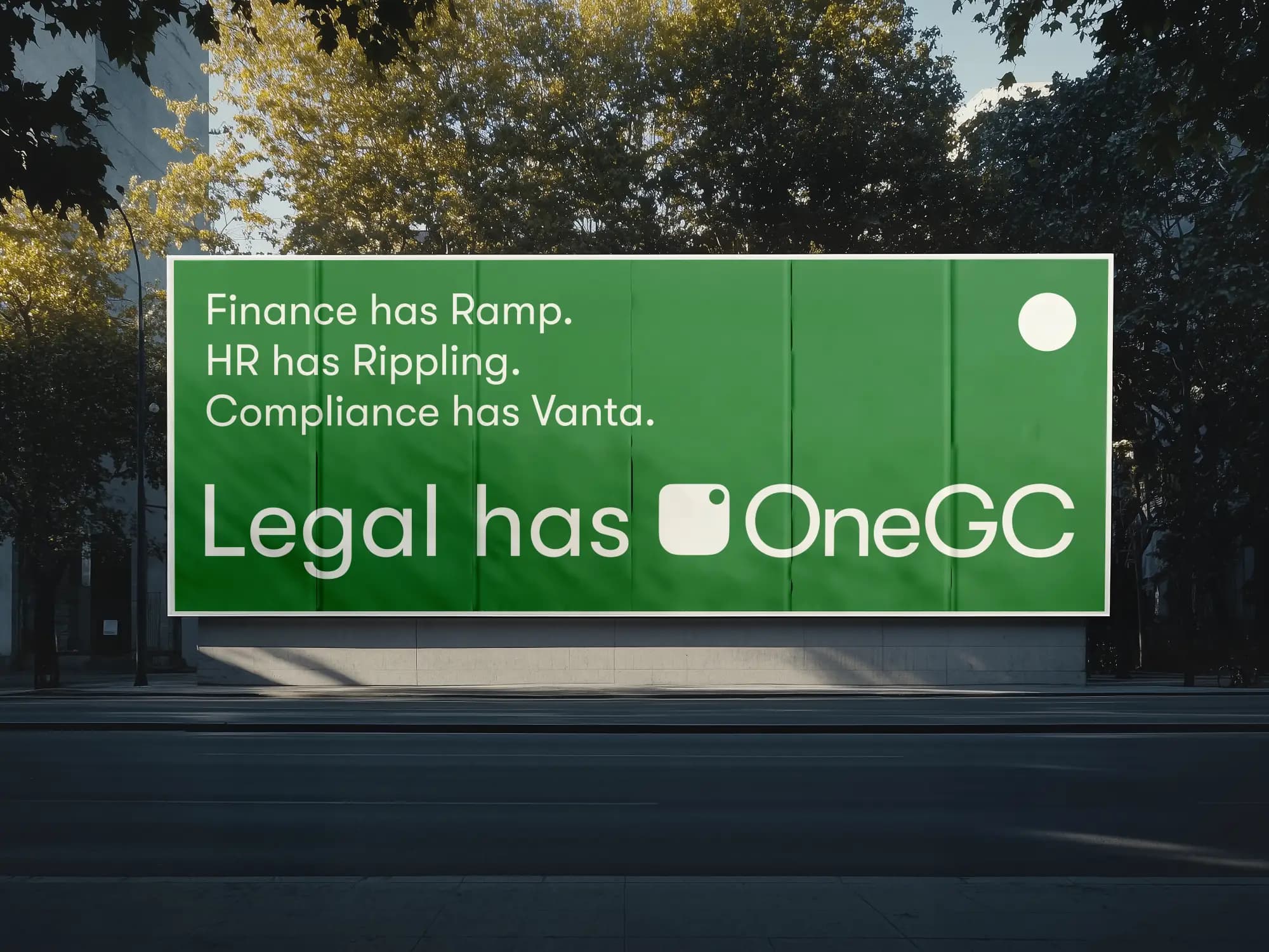 A green outdoor billboard that reads Finance has Ramp. HR has Rippling. Compliance has Vanta. Legal has OneGC.