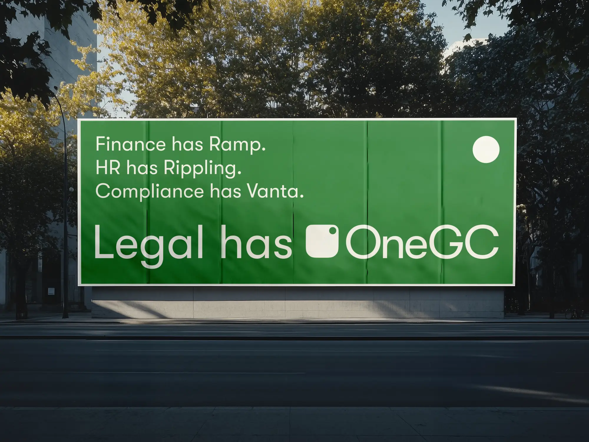A green outdoor billboard that reads Finance has Ramp. HR has Rippling. Compliance has Vanta. Legal has OneGC.